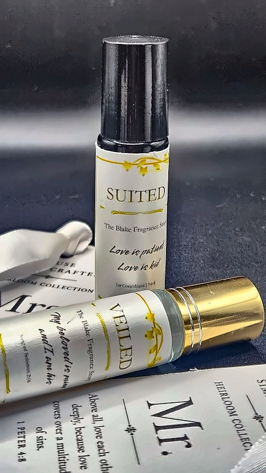 Veiled fragrance roller with gold cap beside Suited, House Simply Crafted