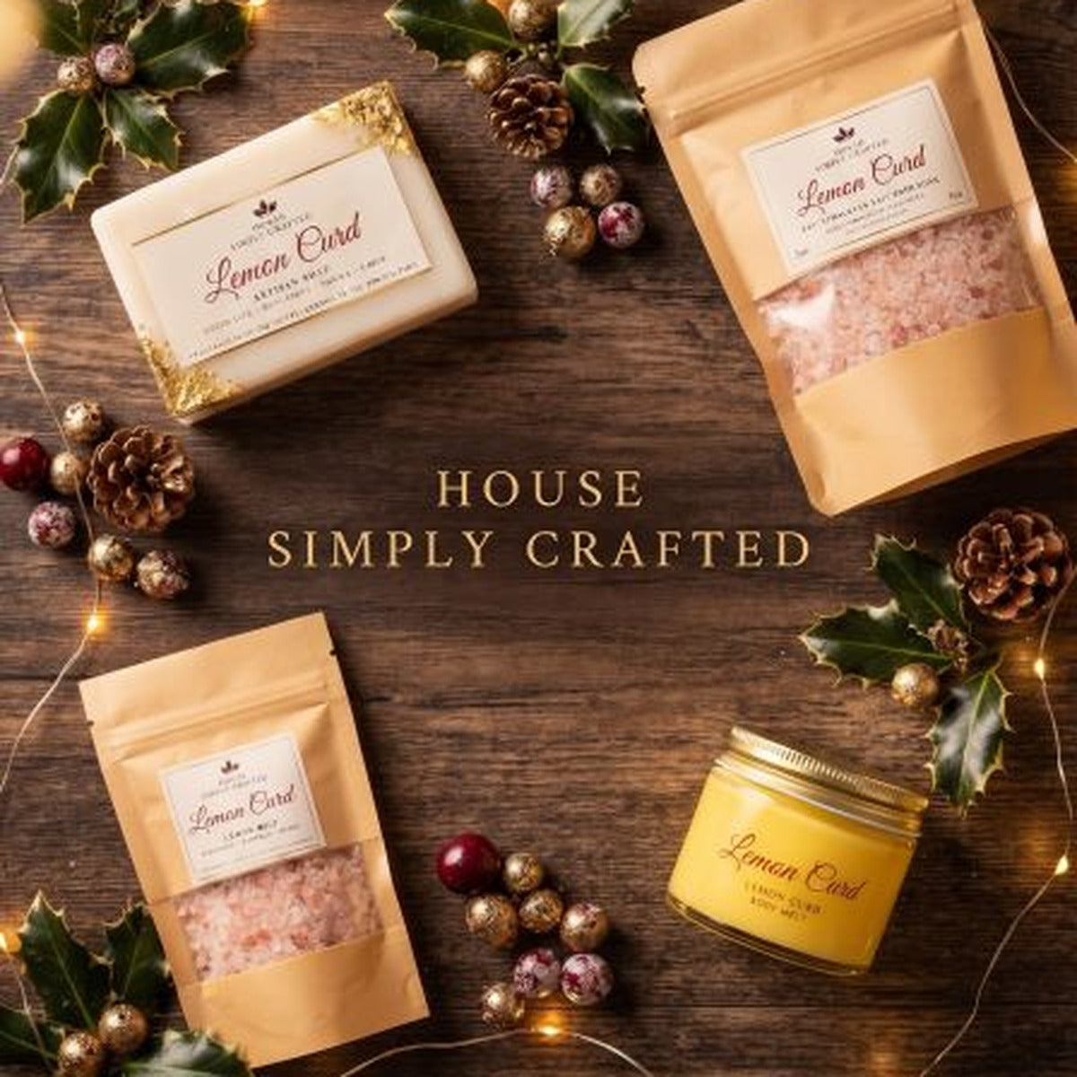 Decadent December holiday bundle in Lemon Curd: artisan soap, bath soak pouches and body melt jar styled on a wood table with holly and string lights (styled preview image)