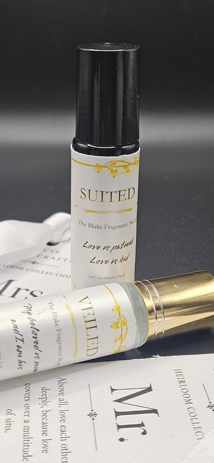 Close-up of the Suited fragrance roller with ivory and gold label beside the wedding keepsake card